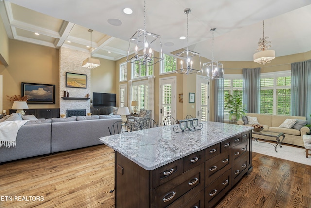 111 Winchester Cir, Oak Ridge, TN 37830 - kitchen featuring open floor plan, a chandelier, wood finished floors, decorative light fixtures, and beamed ceiling
