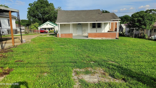 806 Vale St, Loudon, TN 37774 - rear view of house with a shingled roof, a porch, concrete driveway, and brick siding