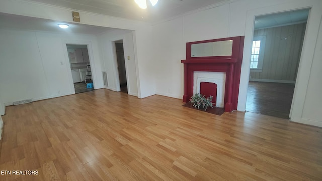 806 Vale St, Loudon, TN 37774 - unfurnished living room featuring light wood-style flooring, a fireplace with flush hearth, ornamental molding, and baseboards