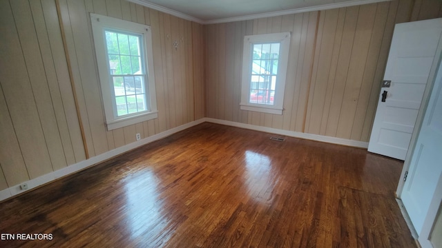 806 Vale St, Loudon, TN 37774 - spare room featuring plenty of natural light, crown molding, wood finished floors, baseboards, and wood walls