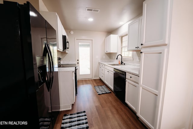 1799 Baker Hwy, Huntsville, TN 37756 - kitchen with black appliances, a sink, dark wood-style flooring, light countertops, and white cabinets