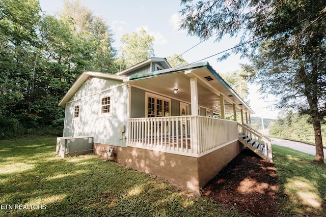 1799 Baker Hwy, Huntsville, TN 37756 - view of side of home featuring central AC unit, covered porch, and a lawn