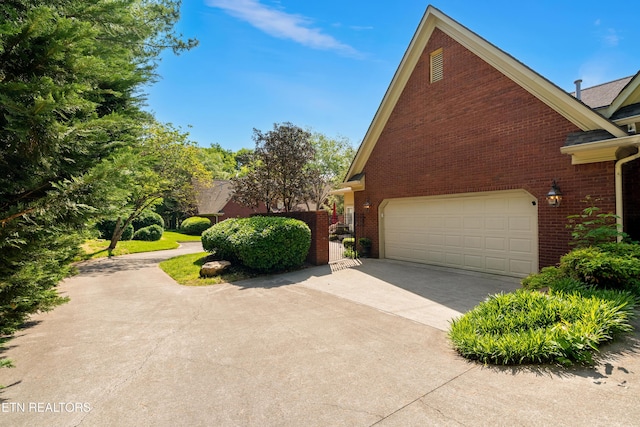 12311 Willow Ridge Ln, Farragut, TN 37934 - view of side of home featuring brick siding, driveway, and an attached garage