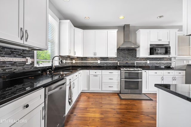 338 Cape Lookout Lgt, Loudon, TN 37774 - kitchen featuring wall chimney exhaust hood, appliances with stainless steel finishes, a sink, white cabinetry, and wood finished floors