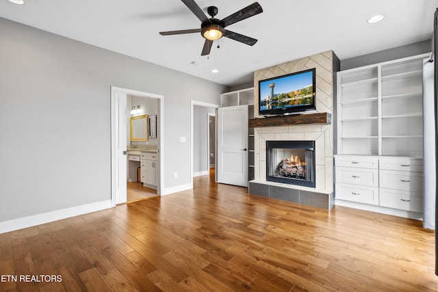 338 Cape Lookout Lgt, Loudon, TN 37774 - unfurnished living room featuring a fireplace, a ceiling fan, baseboards, light wood finished floors, and recessed lighting
