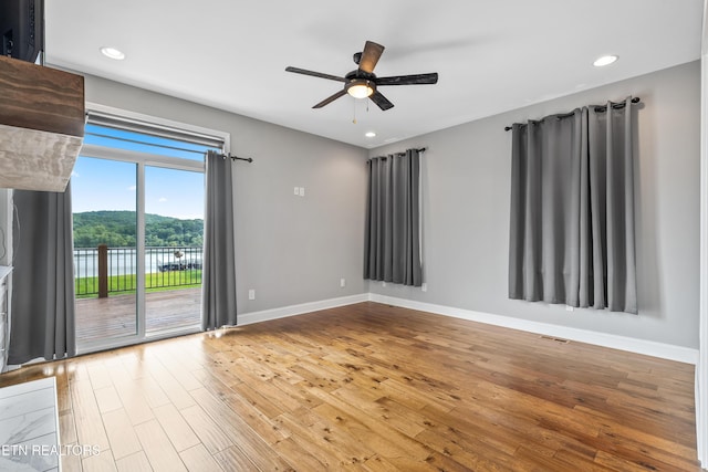 338 Cape Lookout Lgt, Loudon, TN 37774 - unfurnished room with wood finished floors, baseboards, a ceiling fan, recessed lighting, and a water view