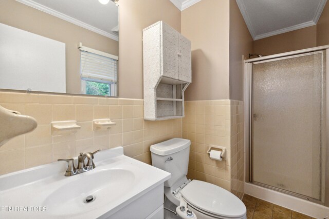 7613 Luscombe Dr, Knoxville, TN 37919 - full bathroom featuring crown molding, a shower stall, tile walls, toilet, and vanity