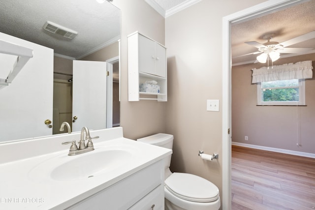 7613 Luscombe Dr, Knoxville, TN 37919 - bathroom featuring wood finished floors, ornamental molding, vanity, toilet, and a textured ceiling