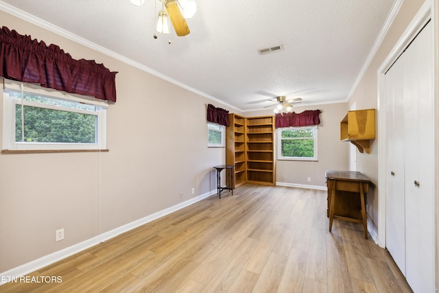 7613 Luscombe Dr, Knoxville, TN 37919 - spare room with a ceiling fan, light wood-style flooring, a textured ceiling, ornamental molding, and baseboards