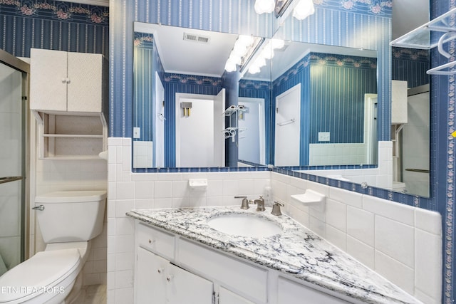 7613 Luscombe Dr, Knoxville, TN 37919 - full bathroom with wallpapered walls, toilet, vanity, tile walls, and wainscoting
