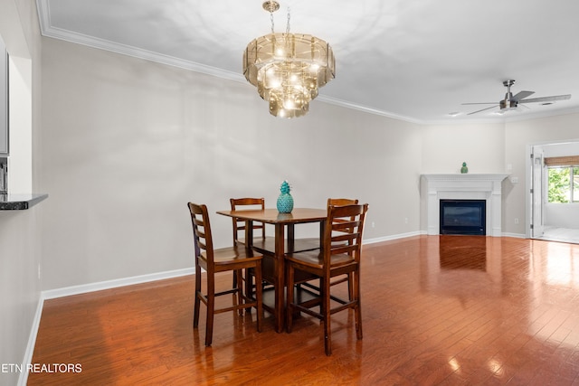 1025 Ree Way Unit 20, Knoxville, TN 37909 - dining space featuring a ceiling fan, ornamental molding, wood finished floors, a glass covered fireplace, and baseboards