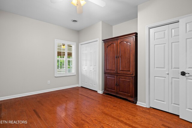 1025 Ree Way Unit 20, Knoxville, TN 37909 - unfurnished bedroom with multiple closets, wood finished floors, baseboards, and ceiling fan