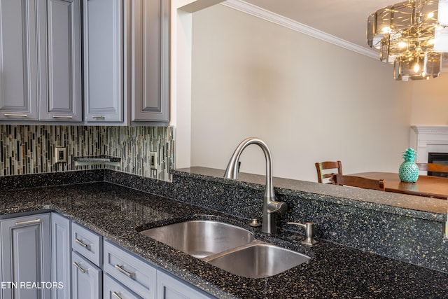 1025 Ree Way Unit 20, Knoxville, TN 37909 - kitchen featuring a sink, crown molding, gray cabinets, decorative backsplash, and dark stone countertops