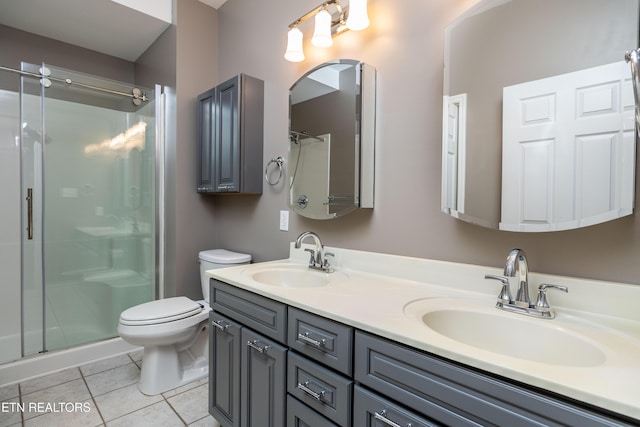1025 Ree Way Unit 20, Knoxville, TN 37909 - bathroom featuring double vanity, a stall shower, toilet, and tile patterned flooring