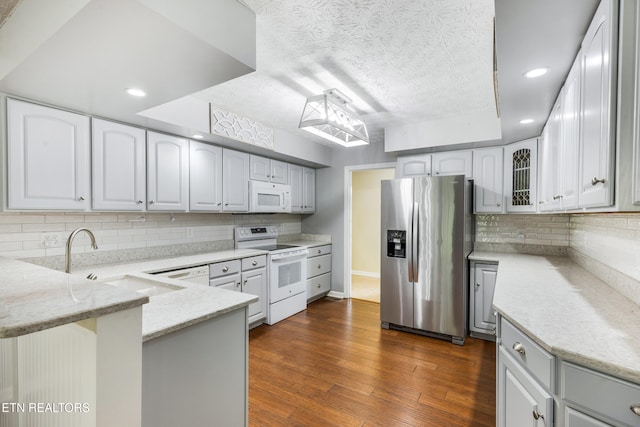6799 Hickory Creek Rd, Lenoir City, TN 37771 - kitchen with white appliances, a sink, a peninsula, light stone countertops, and backsplash