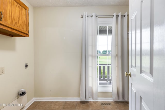 6799 Hickory Creek Rd, Lenoir City, TN 37771 - washroom with cabinet space, baseboards, hookup for an electric dryer, and light tile patterned flooring