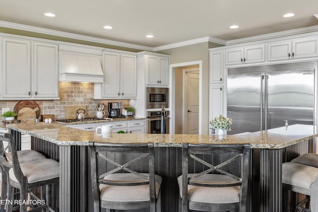 436 Silent River Ln, Loudon, TN 37774 - kitchen with built in appliances, premium range hood, a kitchen breakfast bar, white cabinets, and recessed lighting