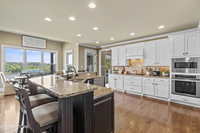 436 Silent River Ln, Loudon, TN 37774 - kitchen with stainless steel appliances, a sink, premium range hood, recessed lighting, and light stone counters