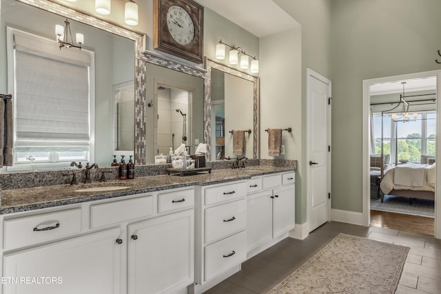 436 Silent River Ln, Loudon, TN 37774 - ensuite bathroom featuring double vanity, a chandelier, a tile shower, and baseboards