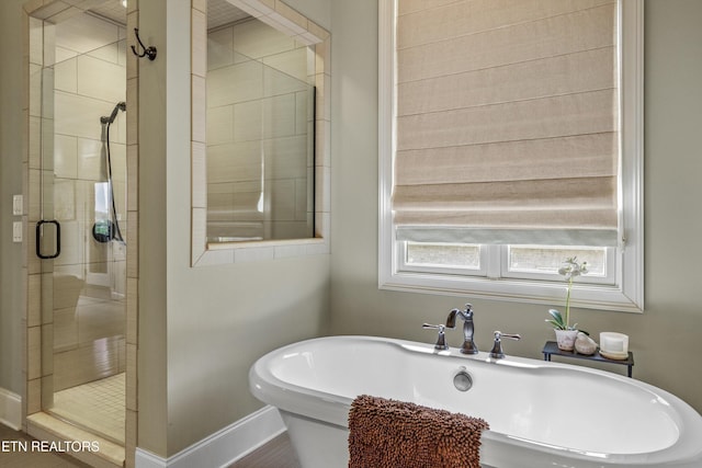 436 Silent River Ln, Loudon, TN 37774 - bathroom with a shower stall, a freestanding tub, and baseboards