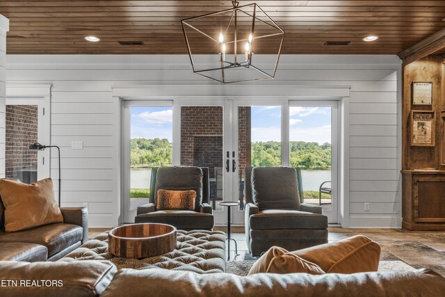 436 Silent River Ln, Loudon, TN 37774 - living room featuring wood ceiling, plenty of natural light, wooden walls, a chandelier, and french doors