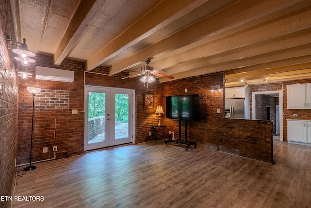 944 Smoky Mountain View Ct, Seymour, TN 37865 - unfurnished living room with a wall mounted air conditioner, brick wall, wood finished floors, french doors, and beam ceiling