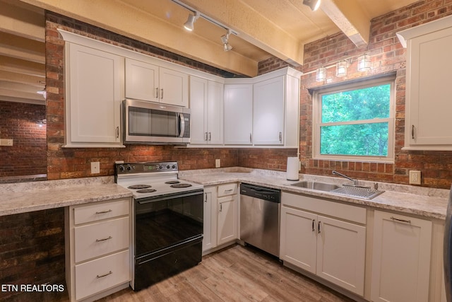 944 Smoky Mountain View Ct, Seymour, TN 37865 - kitchen featuring appliances with stainless steel finishes, a sink, rail lighting, light wood-style flooring, and white cabinetry