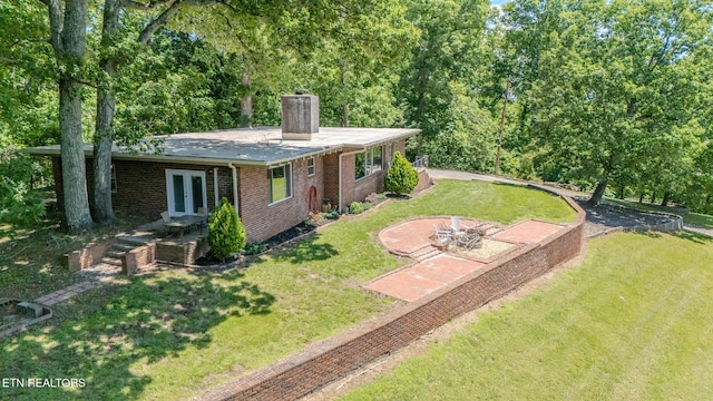 944 Smoky Mountain View Ct, Seymour, TN 37865 - back of house featuring a chimney, brick siding, a yard, and a fire pit