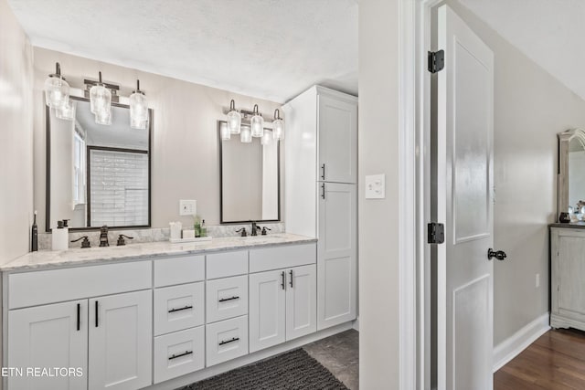 448 Trinity Rd, Morristown, TN 37814 - bathroom featuring double vanity, a textured ceiling, and baseboards