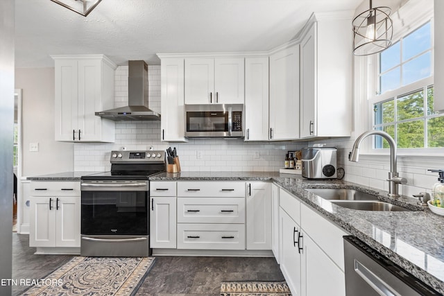 448 Trinity Rd, Morristown, TN 37814 - kitchen featuring appliances with stainless steel finishes, wall chimney exhaust hood, a sink, white cabinetry, and stone countertops