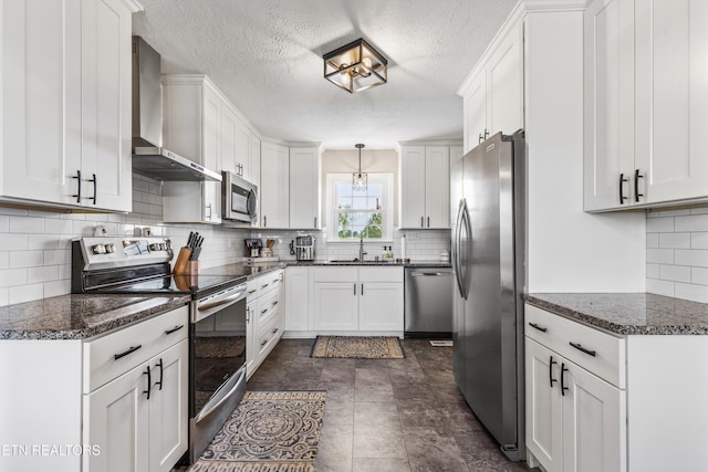 448 Trinity Rd, Morristown, TN 37814 - kitchen featuring stainless steel appliances, wall chimney exhaust hood, a sink, decorative backsplash, and a textured ceiling