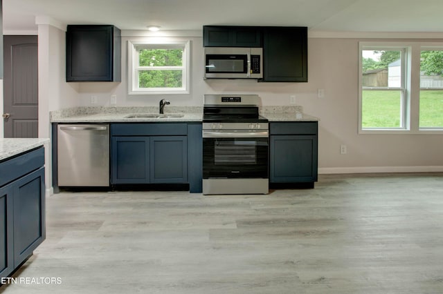 168 Misty Mountain Dr, Maryville, TN 37803 - kitchen with stainless steel appliances, a sink, light wood-type flooring, baseboards, and light stone counters