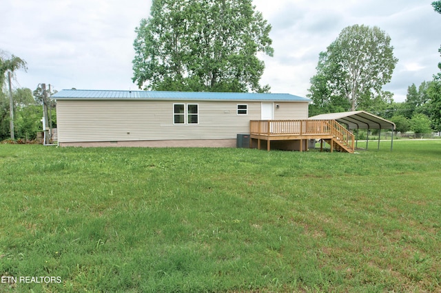 168 Misty Mountain Dr, Maryville, TN 37803 - back of property with a lawn, a deck, metal roof, and a detached carport