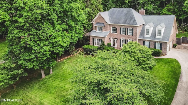 129 Whippoorwill Dr, Oak Ridge, TN 37830 - georgian-style home featuring brick siding, a front yard, a chimney, and a shingled roof