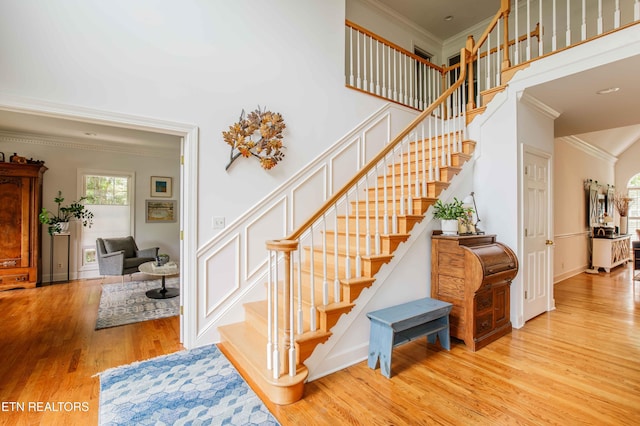 129 Whippoorwill Dr, Oak Ridge, TN 37830 - stairs featuring ornamental molding, wood finished floors, a towering ceiling, and baseboards