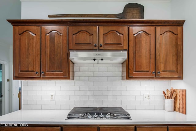 129 Whippoorwill Dr, Oak Ridge, TN 37830 - kitchen with stainless steel gas stovetop, under cabinet range hood, light countertops, and backsplash