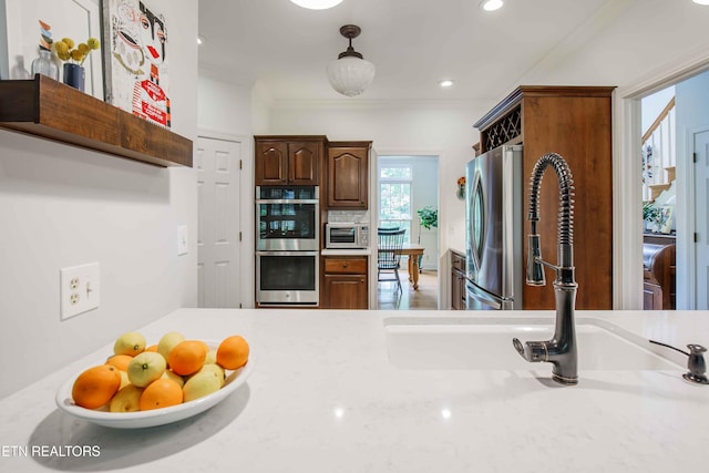 129 Whippoorwill Dr, Oak Ridge, TN 37830 - kitchen featuring stainless steel appliances, light countertops, a sink, ornamental molding, and decorative light fixtures