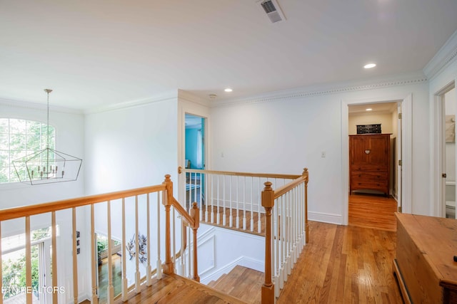 129 Whippoorwill Dr, Oak Ridge, TN 37830 - corridor featuring an upstairs landing, a chandelier, light wood-style flooring, crown molding, and plenty of natural light