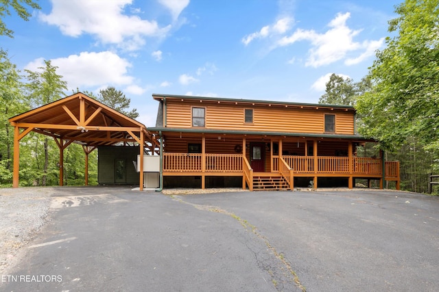 1949 E Mountain View Way, Sevierville, TN 37876 - log cabin with asphalt driveway, an attached carport, and log veneer siding