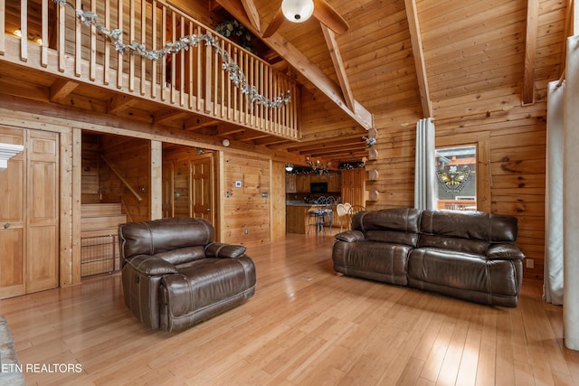 1949 E Mountain View Way, Sevierville, TN 37876 - living room featuring wood walls, wood finished floors, ceiling fan, and wood ceiling with exposed beams