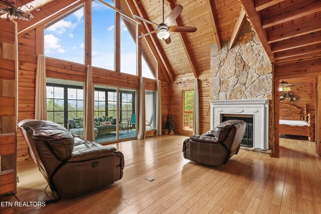 1949 E Mountain View Way, Sevierville, TN 37876 - living room featuring high vaulted ceiling, healthy amount of natural light, a stone fireplace, wood-type flooring, and wooden ceiling with exposed beams