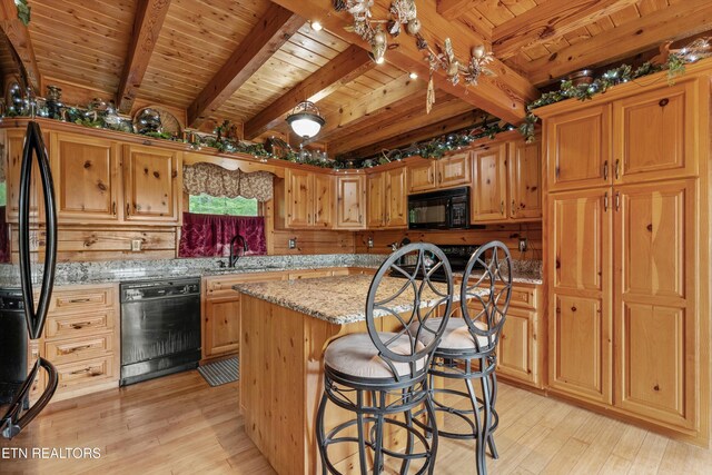 1949 E Mountain View Way, Sevierville, TN 37876 - kitchen with black appliances, wooden ceiling with exposed beams, a sink, light wood-type flooring, and light stone countertops