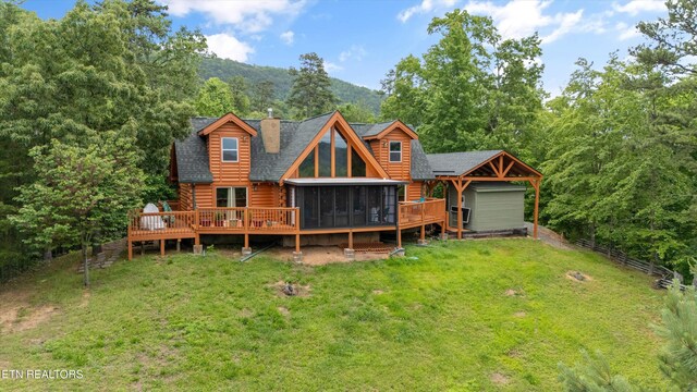 1949 E Mountain View Way, Sevierville, TN 37876 - back of house featuring a sunroom, log siding, roof with shingles, a wooden deck, and a chimney