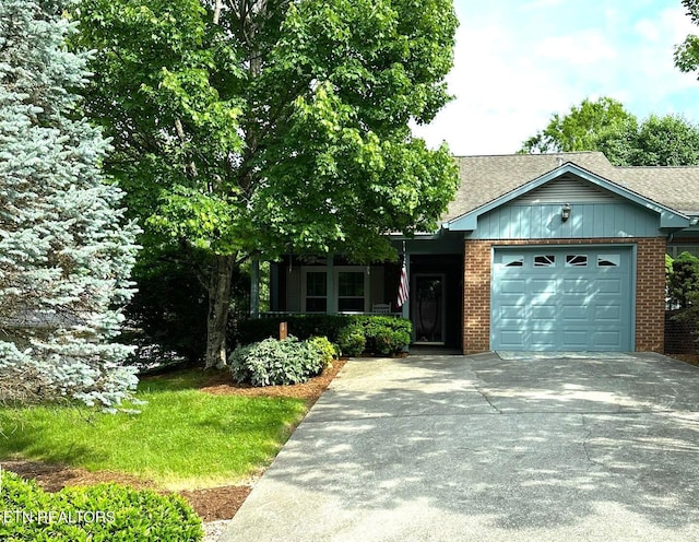 5230 Brig Ln, Knoxville, TN 37914 - view of front of property featuring an attached garage, brick siding, concrete driveway, and a shingled roof