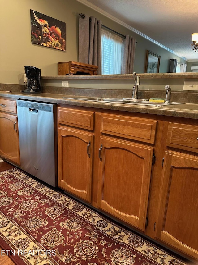 5230 Brig Ln, Knoxville, TN 37914 - kitchen with stainless steel dishwasher, crown molding, a sink, dark countertops, and brown cabinetry