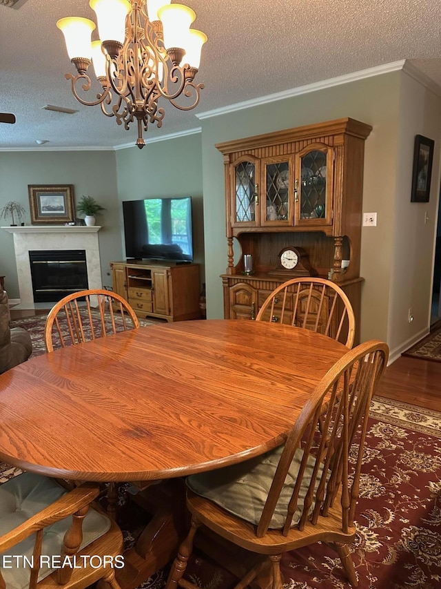 5230 Brig Ln, Knoxville, TN 37914 - dining space featuring a chandelier, wood finished floors, a high end fireplace, a textured ceiling, and ornamental molding