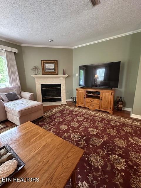 5230 Brig Ln, Knoxville, TN 37914 - living area with a textured ceiling, a high end fireplace, ornamental molding, baseboards, and wood finished floors