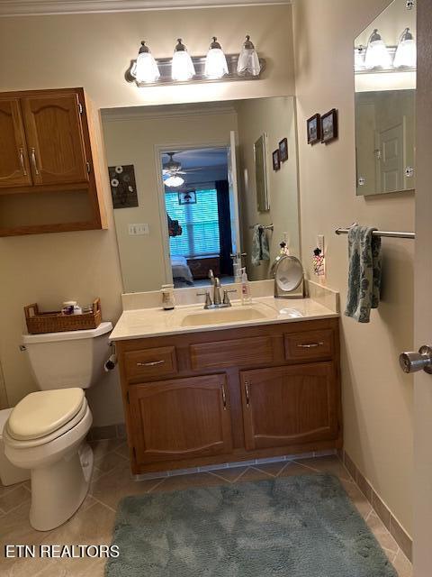 5230 Brig Ln, Knoxville, TN 37914 - bathroom with tile patterned floors, vanity, toilet, and ceiling fan