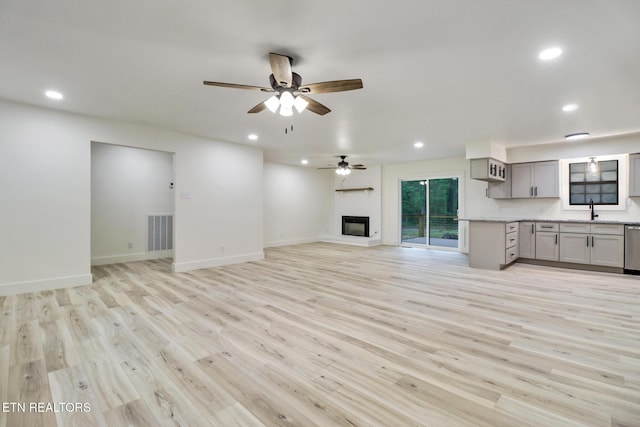 1122 N Shady Lane Loop, Clarkrange, TN 38553 - unfurnished living room featuring recessed lighting, a ceiling fan, light wood finished floors, baseboards, and a sink