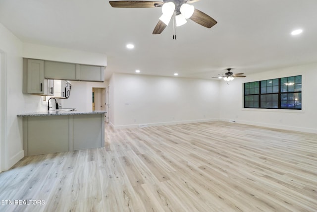 1122 N Shady Lane Loop, Clarkrange, TN 38553 - unfurnished living room with light wood-style flooring, baseboards, a ceiling fan, recessed lighting, and a sink